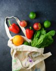Bag with fruits and vegetables on surface — Stock Photo