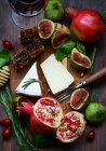 Cheese and fruits on board — Stock Photo