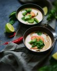 Soups with shrimps and herbs in bowls — Stock Photo