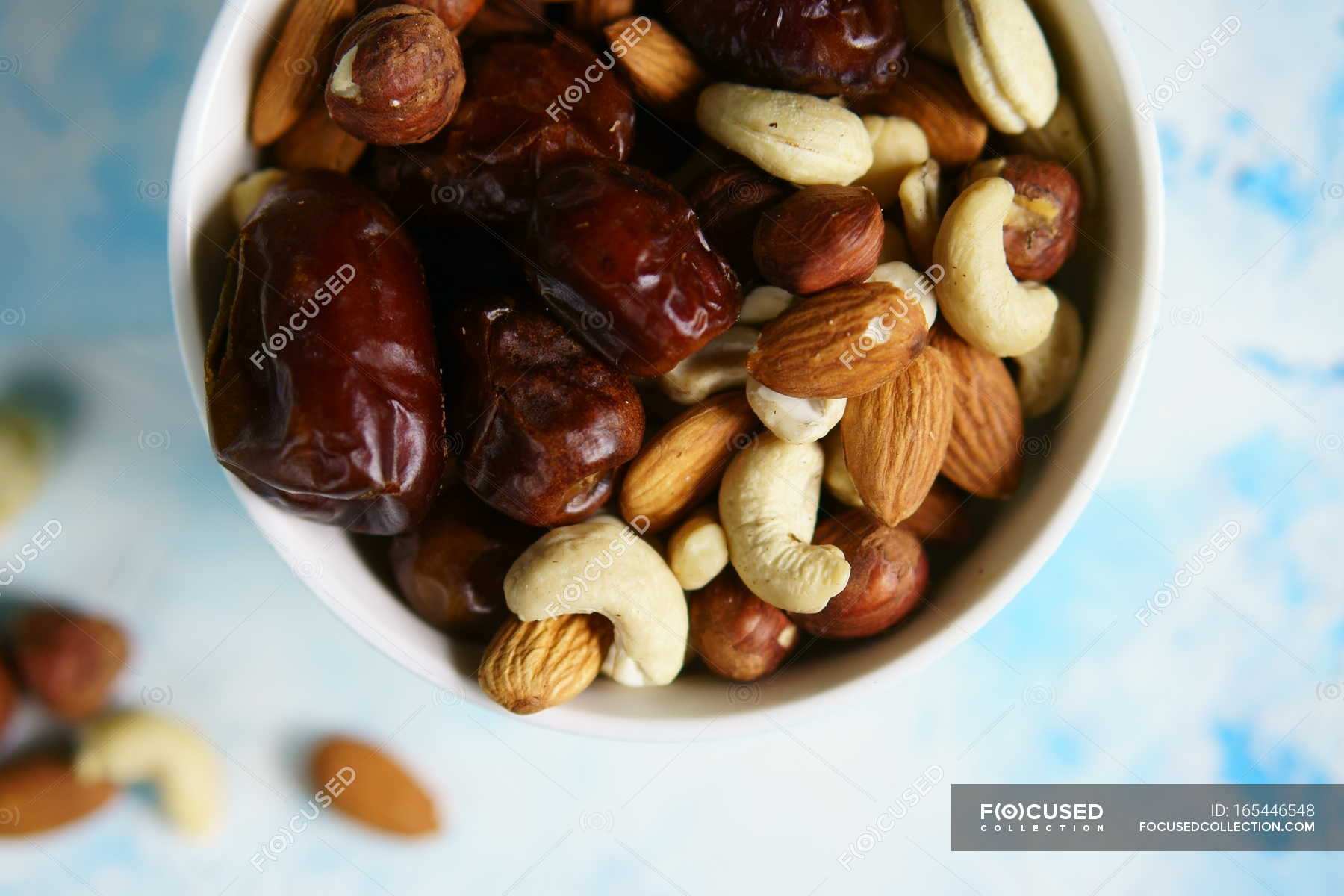 Dates and different nuts — bowl, cashew Stock Photo 165446548