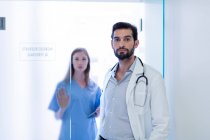 Doctors in hospital looking at camera — Stock Photo