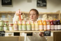 Woman looking at smoothies — Stock Photo