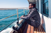 Man on ferry looking away at view — Stock Photo