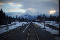 Railway tracks with mountains on background — Stock Photo