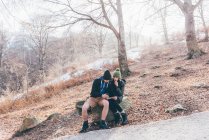 Hiking couple looking at compass and map — Stock Photo