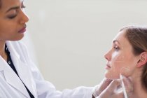 Cirurgião cosmético marcando rosto do paciente — Fotografia de Stock