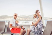 Portrait of family sitting on boat — Stock Photo