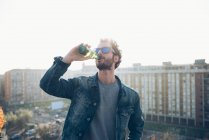 Young man drinking beer — Stock Photo