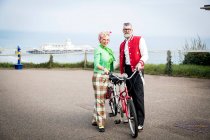 Couple with tandem bicycle at coast — Stock Photo
