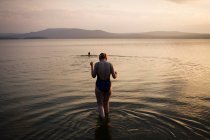 Woman walking in shallow water — Stock Photo