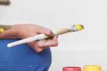 Person holding paintbrush — Stock Photo