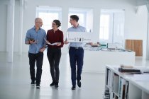 Colleagues walking through office — Stock Photo