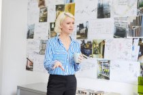 Female architect explaining mood board — Stock Photo