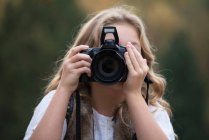Portrait of girl taking photographs — Stock Photo