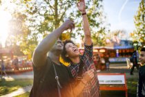 Two male friends at funfair — Stock Photo