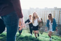 Group of friends running up hill — Stock Photo
