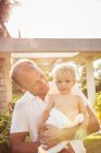 Portrait of father holding young son — Stock Photo