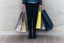 Woman standing with shopping bags — Stock Photo