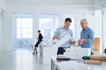 Architects in office looking at architectural model — Stock Photo