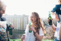 Group of friends holding beer bottles — Stock Photo
