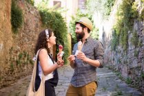 Пара с рожками мороженого на мощеной улице — стоковое фото