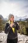 Woman holding binoculars — Stock Photo