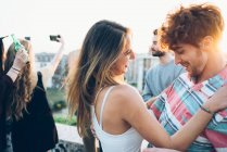 Friends enjoying roof party — Stock Photo