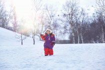 Girl, standing in snowy landscape — Stock Photo