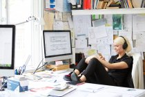 Female with feet up at desk — Stock Photo