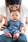 Mother sitting with baby boy — Stock Photo