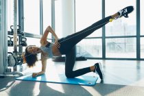 Young woman working out in gym — Stock Photo