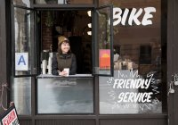 Female employee at service window, Nike and Coffee shop, New York, USA — Stock Photo