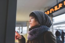 Женщина в вязаной шляпе с сенсорным экраном — стоковое фото