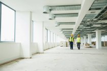 Two workers walking through office — Stock Photo