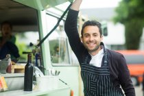 Business owner opening van food stall hatch — Stock Photo