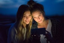 Friends using mobile phone — Stock Photo