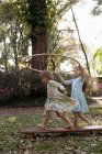 Girls holding plastic hoop — Stock Photo