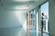 Businessman, looking out of window — Stock Photo