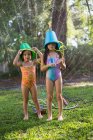 Girls with buckets on head — Stock Photo