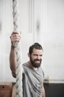 Man holding on to rope — Stock Photo