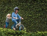 Grandson pushing grandmother on his bicycle — Stock Photo