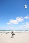 Kite surfer on beach — Stock Photo