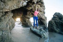 Jovem mulher de pé sobre rochas — Fotografia de Stock