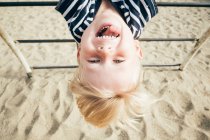 Boy hanging upside down — Stock Photo