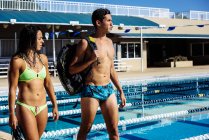 Swimmers walking by pool — Stock Photo
