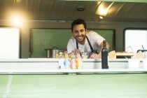 Business owner at van food stall hatch — Stock Photo