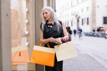 Stylish mature female shopper — Stock Photo