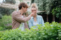 Man and woman in garden — Stock Photo