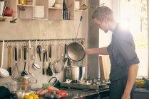 Koch kocht in gewerblicher Küche — Stockfoto