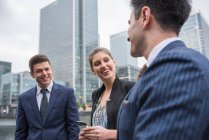 Businessmen and businesswoman in discussion outdoors — Stock Photo